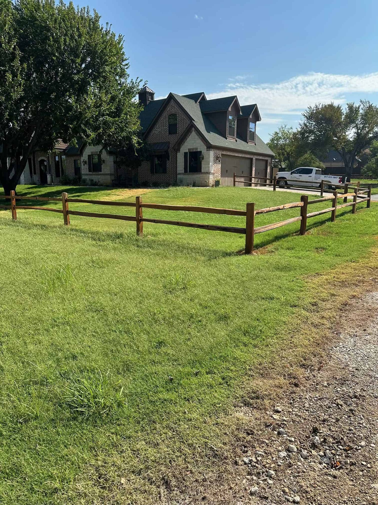 Wood rail fence beside a rural home